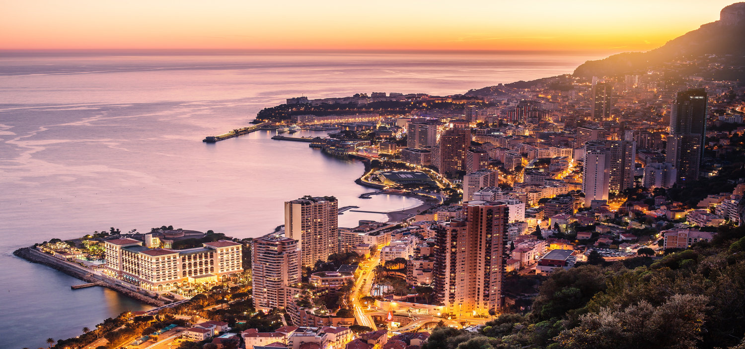 A Monaco yacht charter at night offers amazong views of the Principality